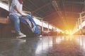 Portrait of a young man traveler waiting for train and travel ba Royalty Free Stock Photo