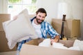 Portrait of young man unpacking carton boxes Royalty Free Stock Photo