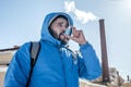 Portrait of young man using asthma inhaler outdoor Royalty Free Stock Photo