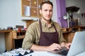 Young Man Using Laptop in Jewelry Workshop