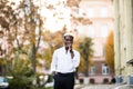 Portrait of a young man walking in the autumn city street Royalty Free Stock Photo