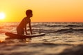 Portrait of young man in water with windsurf board at sunset Royalty Free Stock Photo