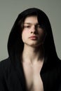 Portrait of young man wearing black hood, athlete or fighter before training, sports and health concept. Handsome guy in Royalty Free Stock Photo