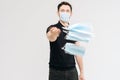 Portrait of young man wearing protective mask throwing medical masks. Royalty Free Stock Photo