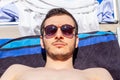 portrait of young man wearing sunglasses and tanning in summer Royalty Free Stock Photo