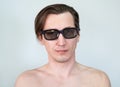 Portrait of young man wearing tinted glasses, naked torso, a long hair Royalty Free Stock Photo