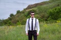 Portrait of young man, wearing white shirt, black tie, suspenders and glasses Royalty Free Stock Photo