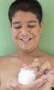 Portrait of young man with white cream. problematic skin and hyperpigmentation on his face smiling at camera Royalty Free Stock Photo