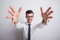 Portrait of a young man in a studio, hands in foregorund. Royalty Free Stock Photo