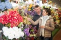 Couple choosing flowers at flower shop Royalty Free Stock Photo