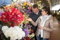 Couple choosing flowers at flower shop Royalty Free Stock Photo