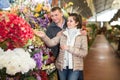 Couple choosing flowers at flower shop Royalty Free Stock Photo