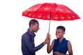 Young man and woman standing under an umbrella Royalty Free Stock Photo