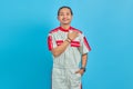 Portrait of young mechanic man greeting with big smile on his face isolated on blue background