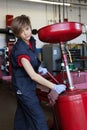 Portrait of a young mechanic working with welding equipment in workshop