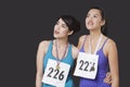 Young medalists looking up against black background Royalty Free Stock Photo