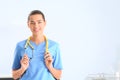 Portrait of young medical assistant with stethoscope in hospital.