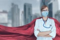 Portrait of young medical doctor hero woman with super person red cape protect city Royalty Free Stock Photo