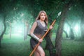 Portrait of a young medieval woman warrior, dressed in chain mail armor with a spear in her hands Royalty Free Stock Photo