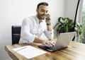 Portrait young mexican attractive businessman working at modern home office with computer laptop Royalty Free Stock Photo