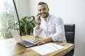 Portrait young mexican attractive businessman working at modern home office with computer laptop Royalty Free Stock Photo