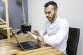 Portrait young mexican attractive businessman working at modern home office with computer laptop Royalty Free Stock Photo