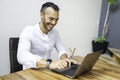 Portrait young mexican attractive businessman working at modern home office with computer laptop Royalty Free Stock Photo