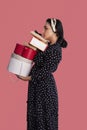 Portrait of young middle-eastern woman holding stack of gift boxes. Receiving lot of presents. Romantic surprises Royalty Free Stock Photo