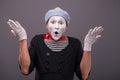 Portrait of young mime boy showing something with Royalty Free Stock Photo