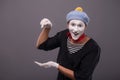 Portrait of young mime boy showing something with Royalty Free Stock Photo