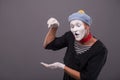 Portrait of young mime boy showing something with Royalty Free Stock Photo