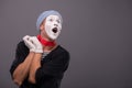 Portrait of young mime boy showing something with Royalty Free Stock Photo