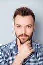 Portrait of young minded man touching his chin Royalty Free Stock Photo