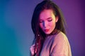 Portrait of a young mixed raced girl with braids against dark blue background Royalty Free Stock Photo