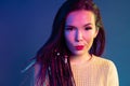 Portrait of a young mixed raced girl with braids against dark blue background Royalty Free Stock Photo