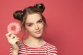 Portrait of young model woman with donut on pink background Royalty Free Stock Photo