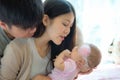 Portrait of young mother and father with newborn in bed room, Fa Royalty Free Stock Photo