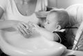 Portrait of young mother feeding her baby on kitchen Royalty Free Stock Photo
