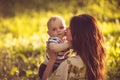 Portrait of young mother and her baby boy, time for kisses. Royalty Free Stock Photo