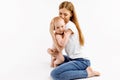 Loving mom hugs and kisses her baby on isolated white background Royalty Free Stock Photo