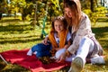 A Portrait Of Young Mother With A Small Daughter In Autumn Nature At Sunset. Royalty Free Stock Photo