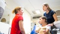 Portrait of young mother talking to pediatric dentist in clinic Royalty Free Stock Photo