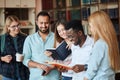 Portrait of young multicultural friends reading books together in the library Royalty Free Stock Photo