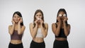 Portrait of young multiethnic models on white studio background close up. Group of three multiracial girls posing at the Royalty Free Stock Photo