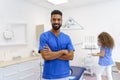 Portrait of young multiracial dentist at private dental clinic.