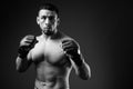 Portrait of young muscular Hispanic man as boxer shirtless