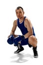 Portrait of young muscular, professional boxer posing in uniform isolated over white background Royalty Free Stock Photo