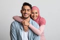 Portrait Of Muslim Couple Embracing Over Grey Background And Smiling At Camera Royalty Free Stock Photo