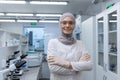 Portrait of a young Muslim female lab technician, pharmacist in hijab and protective glasses, standing in medical Royalty Free Stock Photo