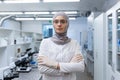 Portrait of a young Muslim female lab technician, pharmacist in hijab and protective glasses standing in medical Royalty Free Stock Photo